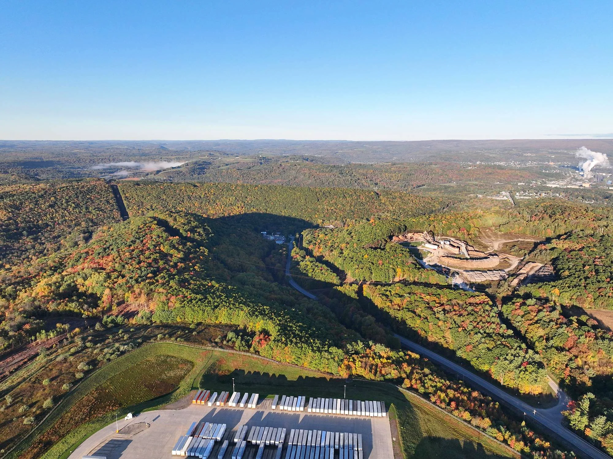 Aerial view of a distribution center and trailer yard in the hills